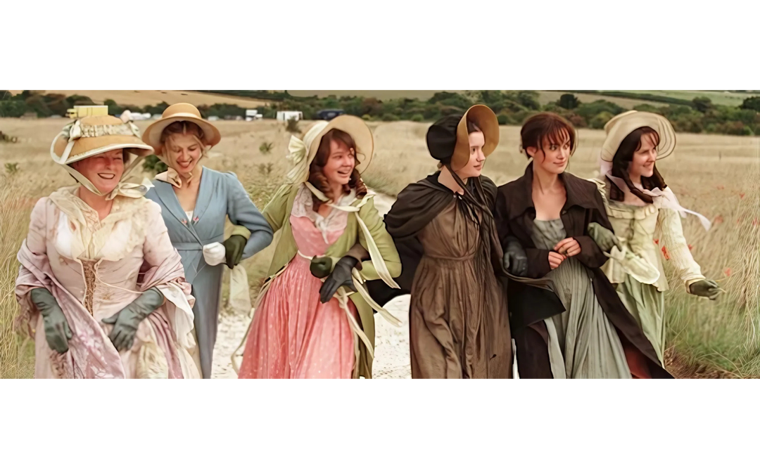 Six women in Regency-era dresses and bonnets walk arm in arm through a countryside field, smiling and laughing together.