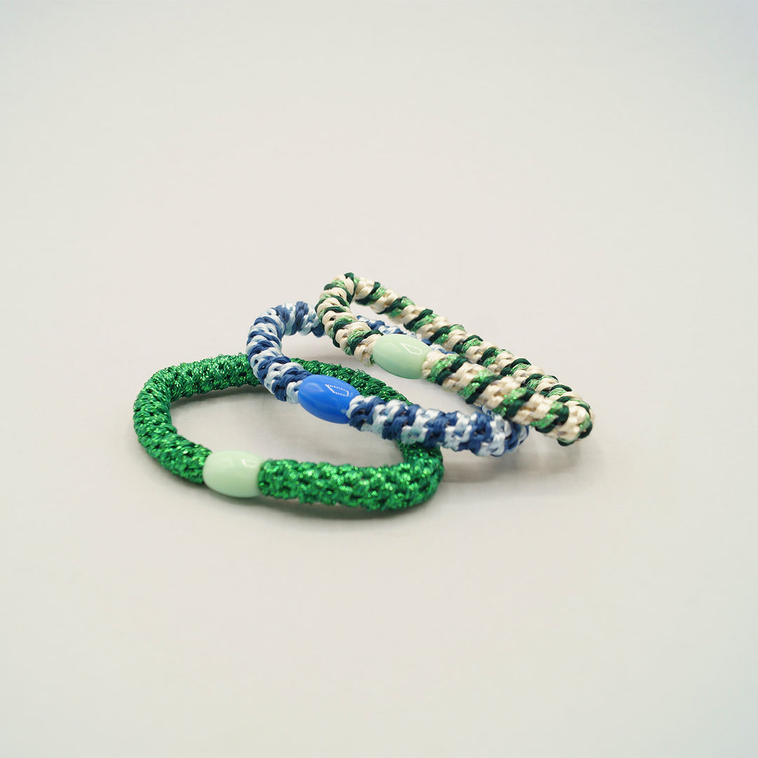 a set of three stretchy elastic bracelets.