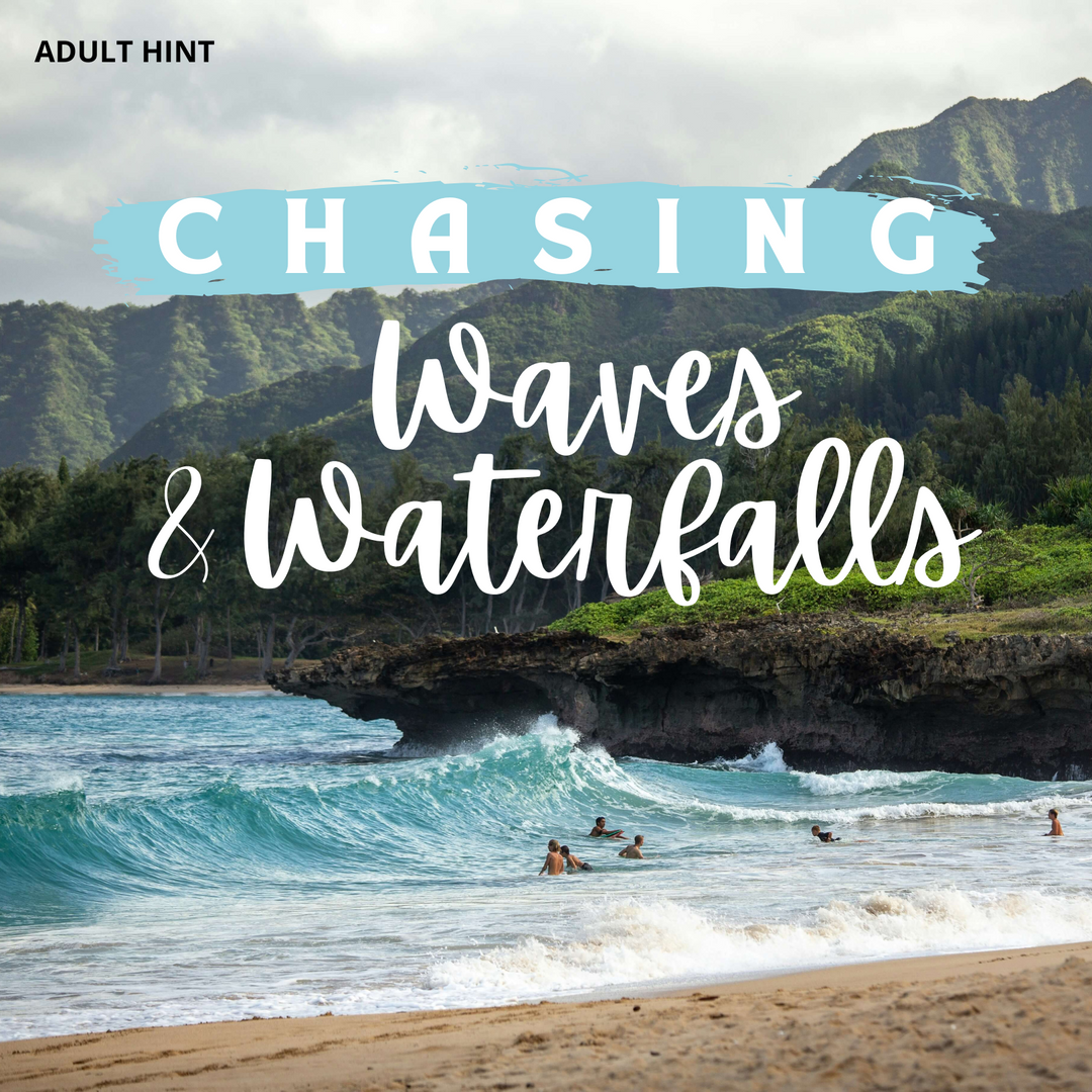 A gorgeous coastal beach with large, clear blue waves heading toward the sand. Surfers and swimmers are in the shallow water. Lush green hills and mountains rise in the background from the cliffs. The words "Chasing Waves & Waterfalls" is written in white font across the middle of the image. The words "Adult Hint" are in the upper left corner.