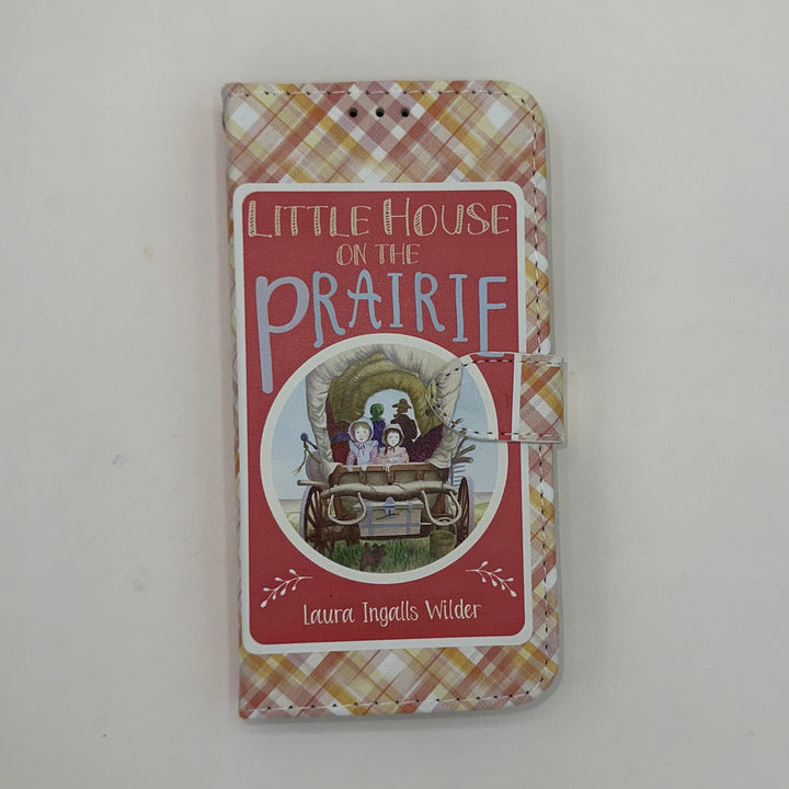 The front of a book shaped phone case inspired by Little House on the Prairie by Laura Ingalls Wilder.