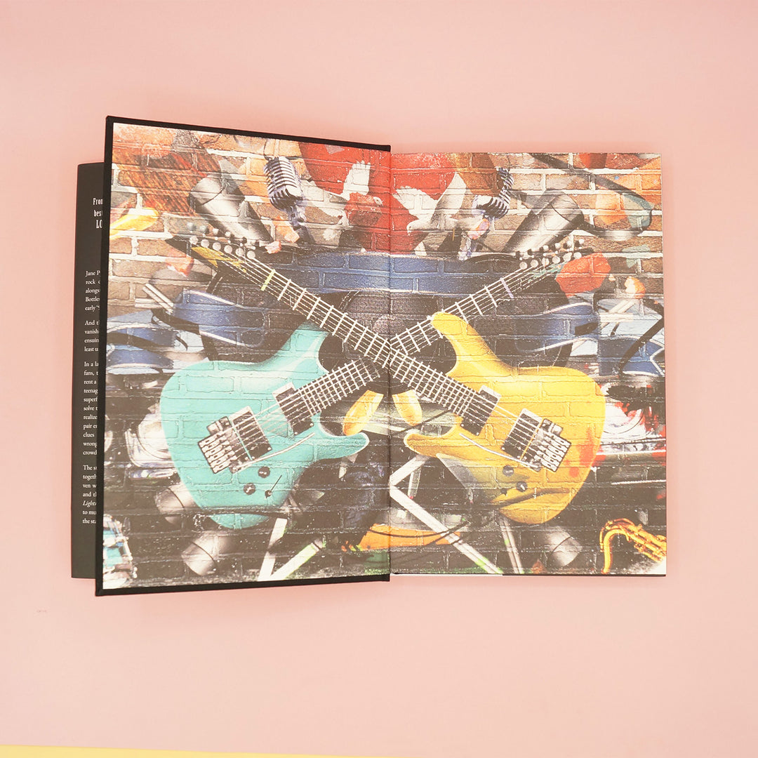 the custom end papers of the custom edition of The Lightning Bottles by Marissa Stapley featuring graffiti style electric guitars, stage equipment, and spray paint.