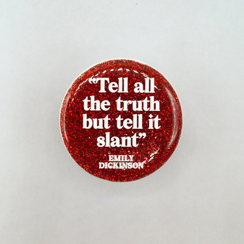 A red glittery phone grip with an Emily Dickinson quote "Tell all the truth but tell it slant"