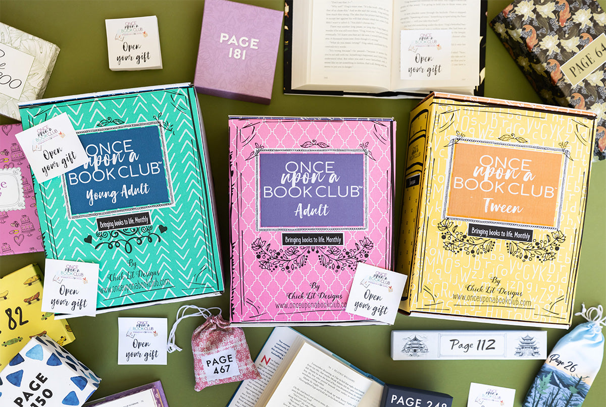 Three Once Upon a Book Club boxes for Young Adult, Adult, and Tween surrounded by gifts.