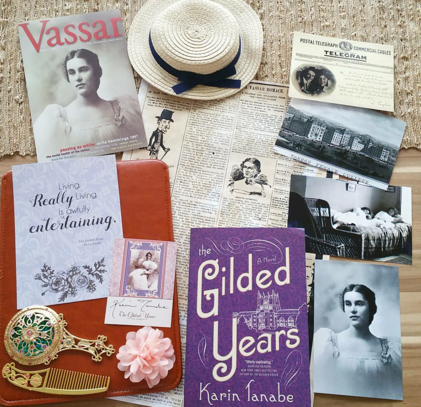 The Gilded Years book sits surrounded by a variety of items including black&white photos, a comb, newspaper clippings, and a hat