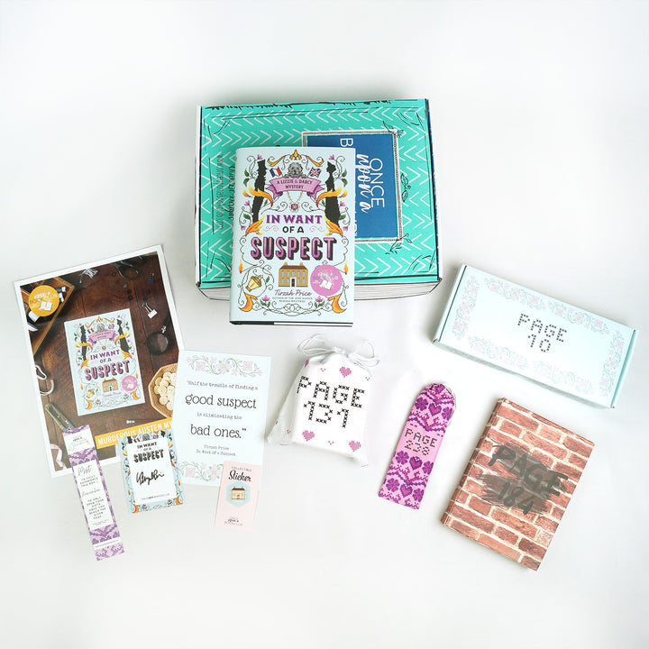 A flat-lay of book-themed subscription box items featuring "In Want of a Suspect" and related gifts.